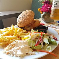 "The Rails" burger. Succulent homemade burger in a seeded bun. Cheese, onion rings & the works.