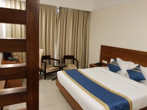 Heaven View Clarks Inn in Kanpur, image may contain: Bed, Furniture, Hotel, Chair