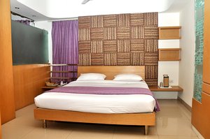 Hotel Apna Palace in Indore, image may contain: Interior Design, Indoors, Hotel, Furniture