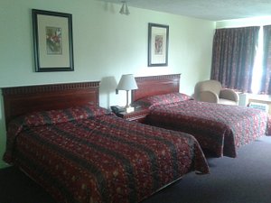 Fort Nashwaak Motel in Fredericton, image may contain: Bed, Furniture, Bedroom, Chair