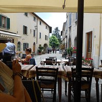 Quiet narrow village street, no cars, quiet, just people out and about