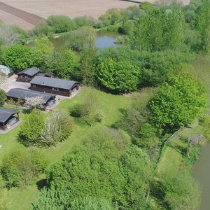 Drone view of the lodges and the surrounding fields and lakes May 18