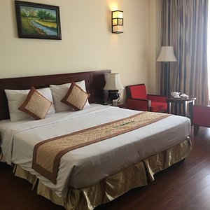 Dlgl - Dung Quat Hotel in Quang Ngai, image may contain: Bed, Furniture, Lamp, Chair