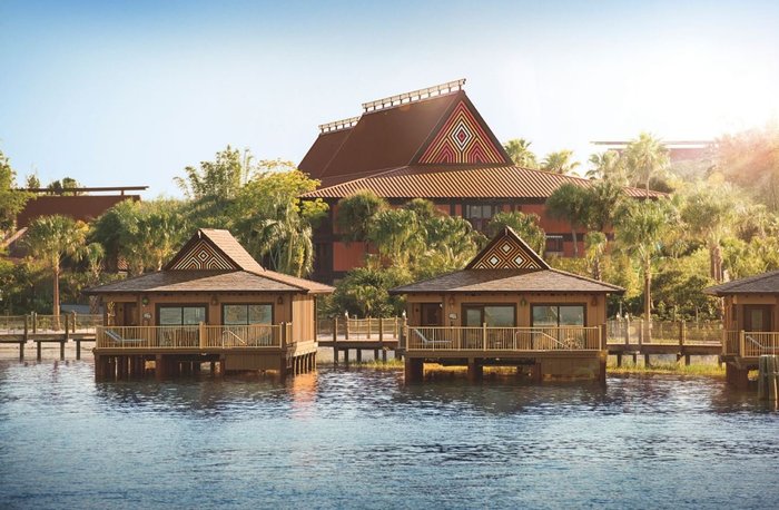 Disney's Polynesian Village Resort with people staying there. Water in the foreground