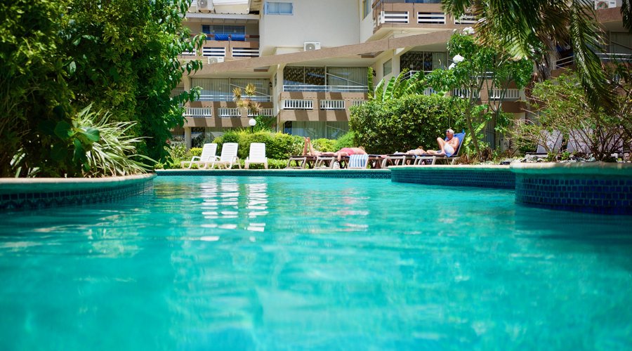 Pool Area set against the Lush Tropical Backdrop of Resort 