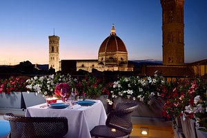 San Firenze Suites & Spa in Florence, image may contain: Dining Table, Potted Plant, Tablecloth, Dining Room