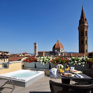San Firenze Suites & Spa in Florence, image may contain: Dining Table, Potted Plant, Tablecloth, Dining Room