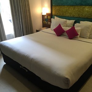 La Woods Hotel in Chennai (Madras), image may contain: Bed, Furniture, Cushion, Home Decor