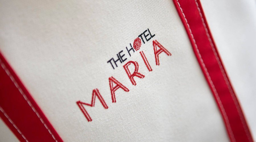 The Hotel Maria signature beach bag is in room with towels for a day at the beach