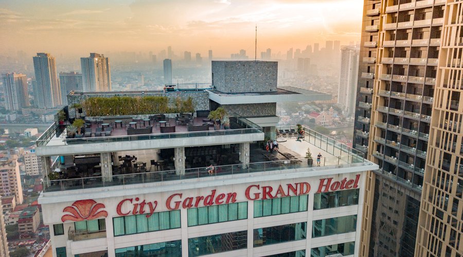 Facade shot and rooftop of City Garden GRAND Hotel, with view of the pool area and FIrefly Roofd