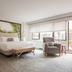 The Gardens Sonesta ES Suites New York in New York City, image may contain: Home Decor, Rug, Furniture, Couch