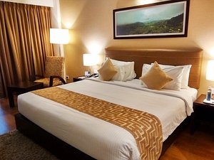Signature Club Resort in Bengaluru, image may contain: Bed, Furniture, Monitor, Cushion