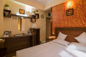 Blue Bell Airport Hotel in Nedumbassery, image may contain: Plant, Bed, Furniture, Bedroom