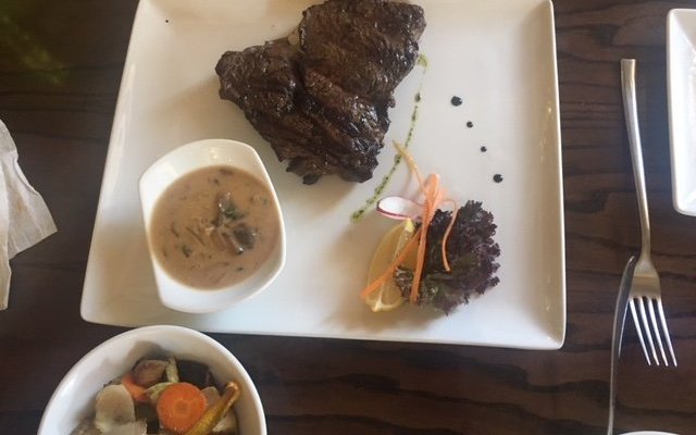 Steak medium rare with mushroom sauce, cooked to perfection