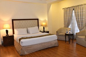 Royalton Hotel in Rawalpindi, image may contain: Bed, Home Decor, Lamp, Table Lamp