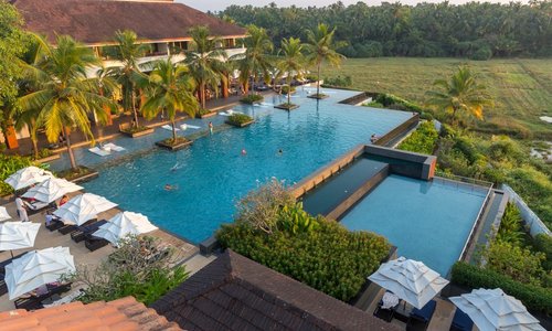 Hotel, main pool and paddy fields