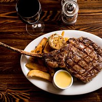 Grilled 30oz Tomahawk Ribeye - served w/truffle fries & garlic aioli