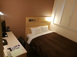 Sanco Inn Nagoya Shinkansenguchi in Nagoya, image may contain: Dorm Room, Furniture, Bed, Bedroom