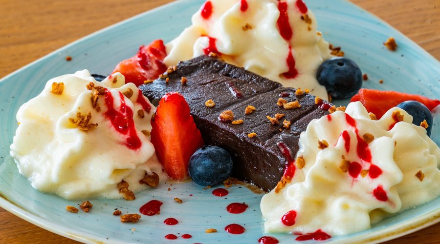 Brownie with whipped yogurt and berries.
