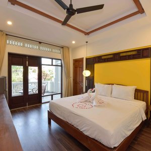 An Bang Beach Villa in Hoi An, image may contain: Ceiling Fan, Electrical Device, Device, Door