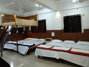 Joshi Yatri Niwas in Kolhapur, image may contain: Hostel, Housing, Bed, Furniture