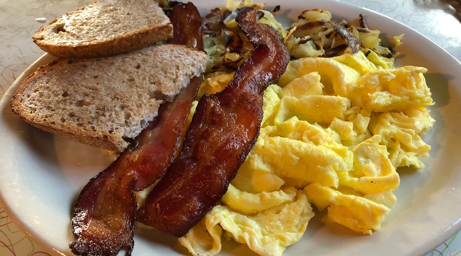 eggs and hash browns with rye toast and bacon
