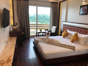 Comfort Inn Benares in Varanasi, image may contain: Bed, Penthouse, Hotel, Monitor