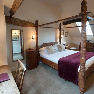 The antique four post bed and exposed beams give this room lots of character