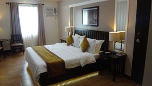 Prime City Resort Hotel in Luzon, image may contain: Chair, Furniture, Bed, Bedroom