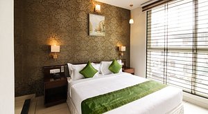 Treebo Trend Maharaja Inn in Chikmagalur, image may contain: Interior Design, Home Decor, Corner, Cushion