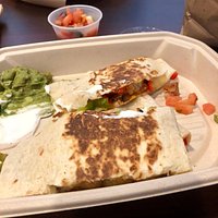 Chicken quesadilla with peppers, cheese, guac and sour cream