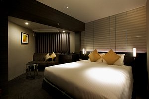 Hotel Trusty Nagoya Shirakawa in Sakae, image may contain: Interior Design, Home Decor, Bed, Lighting