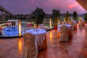 The Atrium Boutique Hotel in Mysuru (Mysore), image may contain: Resort, Hotel, Dining Table, Chair