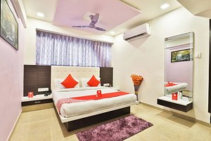 OYO 11557 Hotel Maharaja Palace in Ahmedabad, image may contain: Home Decor, Ceiling Fan, Electrical Device, Rug
