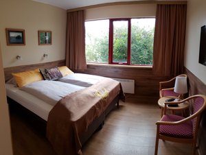 Hotel Smyrlabjorg in Hornafjorour, image may contain: Bed, Furniture, Chair, Interior Design