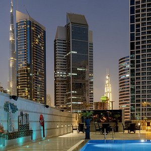Outdoor swimming pool night time with Burj Khalifa View