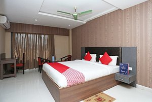 Hotel Richi Regency in Bhubaneswar, image may contain: Interior Design, Ceiling Fan, Furniture, Bed