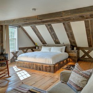 Willard room boasts antique wooden floors and some beautiful, recent woodwork for a stunning eff