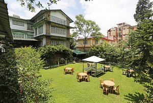 Capital O 2402 Hotel HighWinds in Shillong, image may contain: Resort, Hotel, Grass, Person