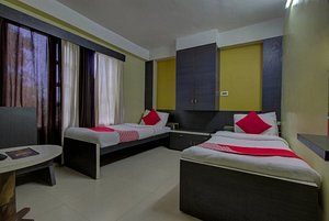 Jagat Hotel in Dumriguri, image may contain: Bed, Furniture, Resort, Hotel