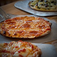 Our pizzas are 9", thin crust, hand-made, cooked in our wood-fired oven.