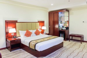 Swiss-Belhotel Blulane in Luzon, image may contain: Home Decor, Corner, Furniture, Bed