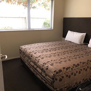 Quality Suites Amore in Christchurch, image may contain: Furniture, Bed, Bedroom, Room
