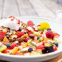 Tropical buckwheat, cacao & hempseed granola with fresh spring fruits, coconut ice-cream and coconut milk.