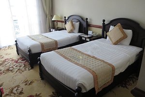 Sammy Dalat Hotel in Da Lat, image may contain: Bed, Furniture, Bedroom, Lamp