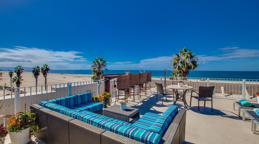 Rooftop terrace with patio furniture and lounge chairs 