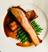 Slow roasted belly of pork with fennel seeds, pressed potato & apple, green beans with a red wine sauce. (from the to follow section)