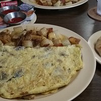 Tasty omelet with home fries and biscuit