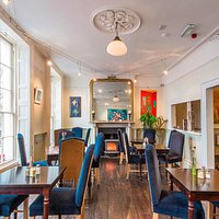 A warm and inviting restaurant, natural wood stove, comfortable seating to relax and enjoy your vegetarian or vegan meal.