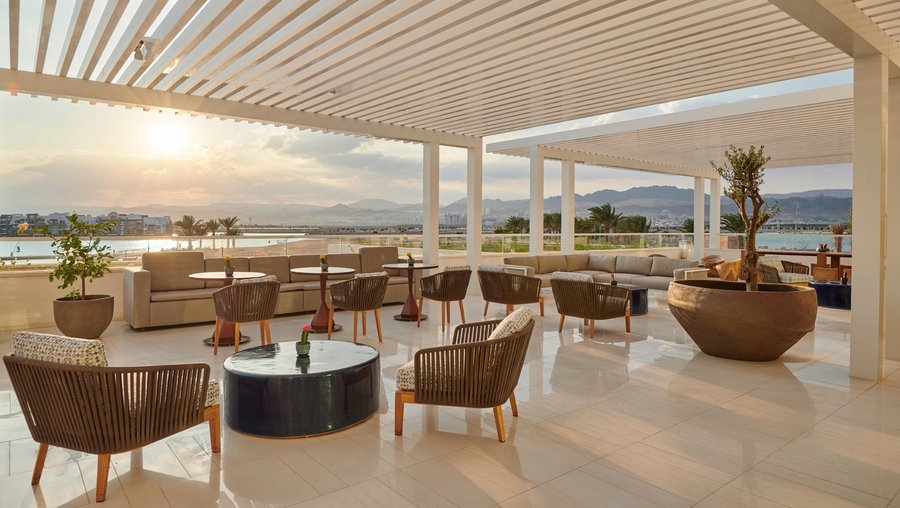 Regency Club™ Lounge with floor to ceiling glass windows, featuring an indoor lounge with fireplace as well as an outdoor terrace with spectacular views overlooking the marina.